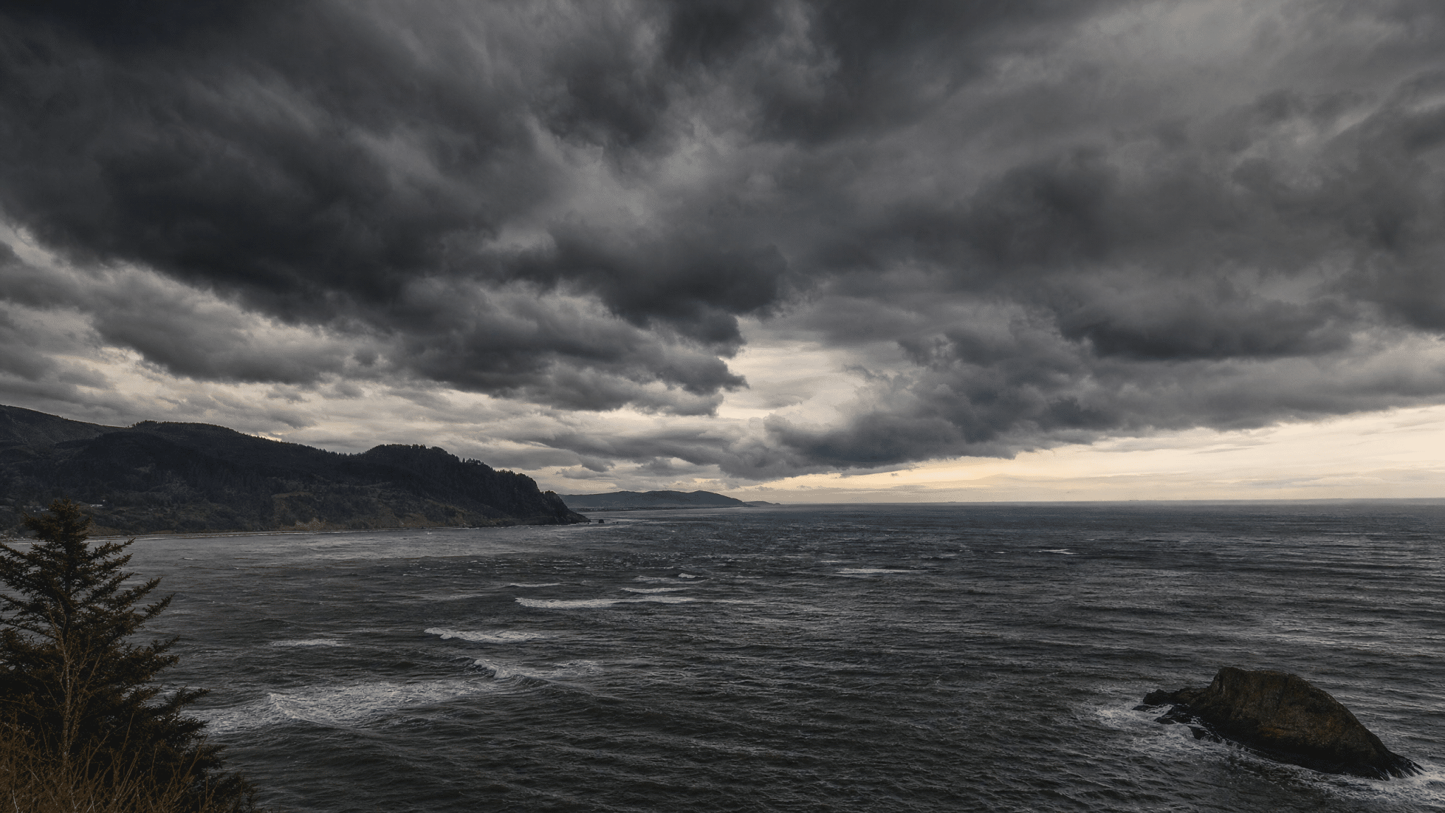 Dramatic storm clouds and rough seas near Astoria on Oregon Coast