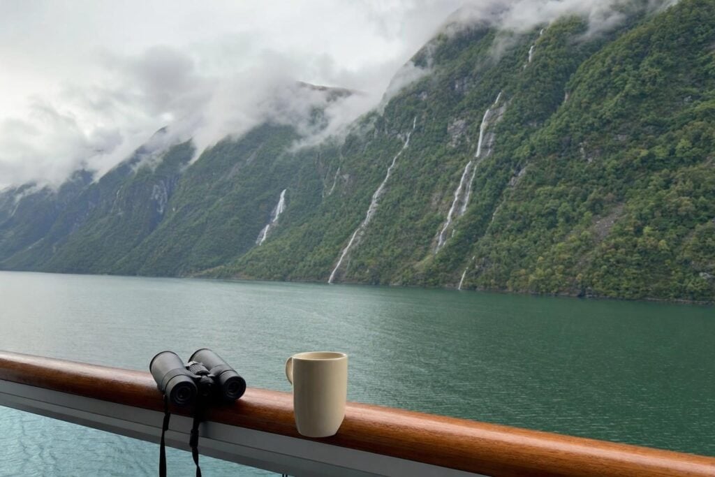 Balcony view of a misty fjord with forested mountains on a 7 day Inside Passage cruise from Vancouver