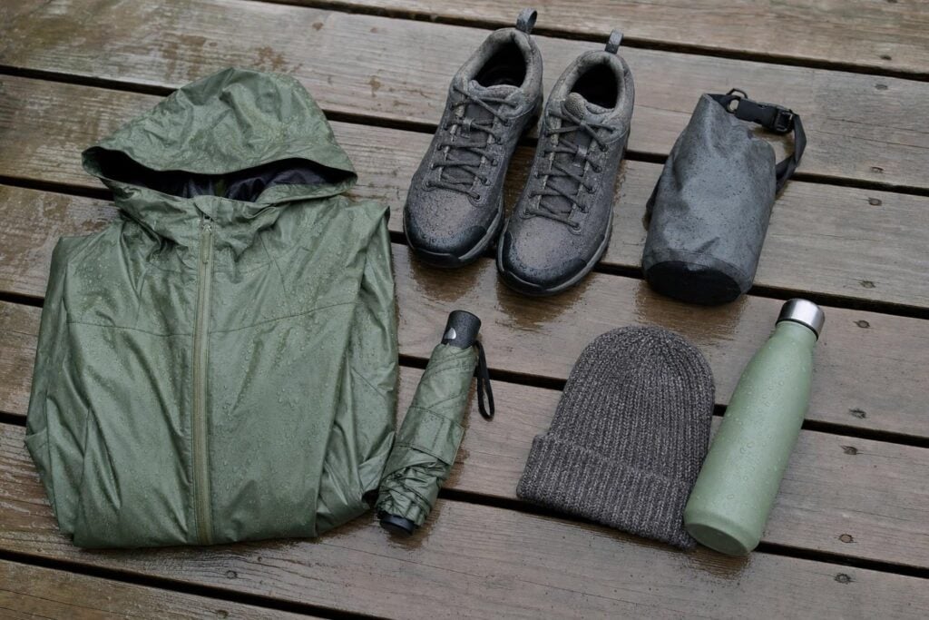 Flat-lay of rain jacket, waterproof shoes and dry bag, packing for a rainy Ketchikan Alaska cruise port day